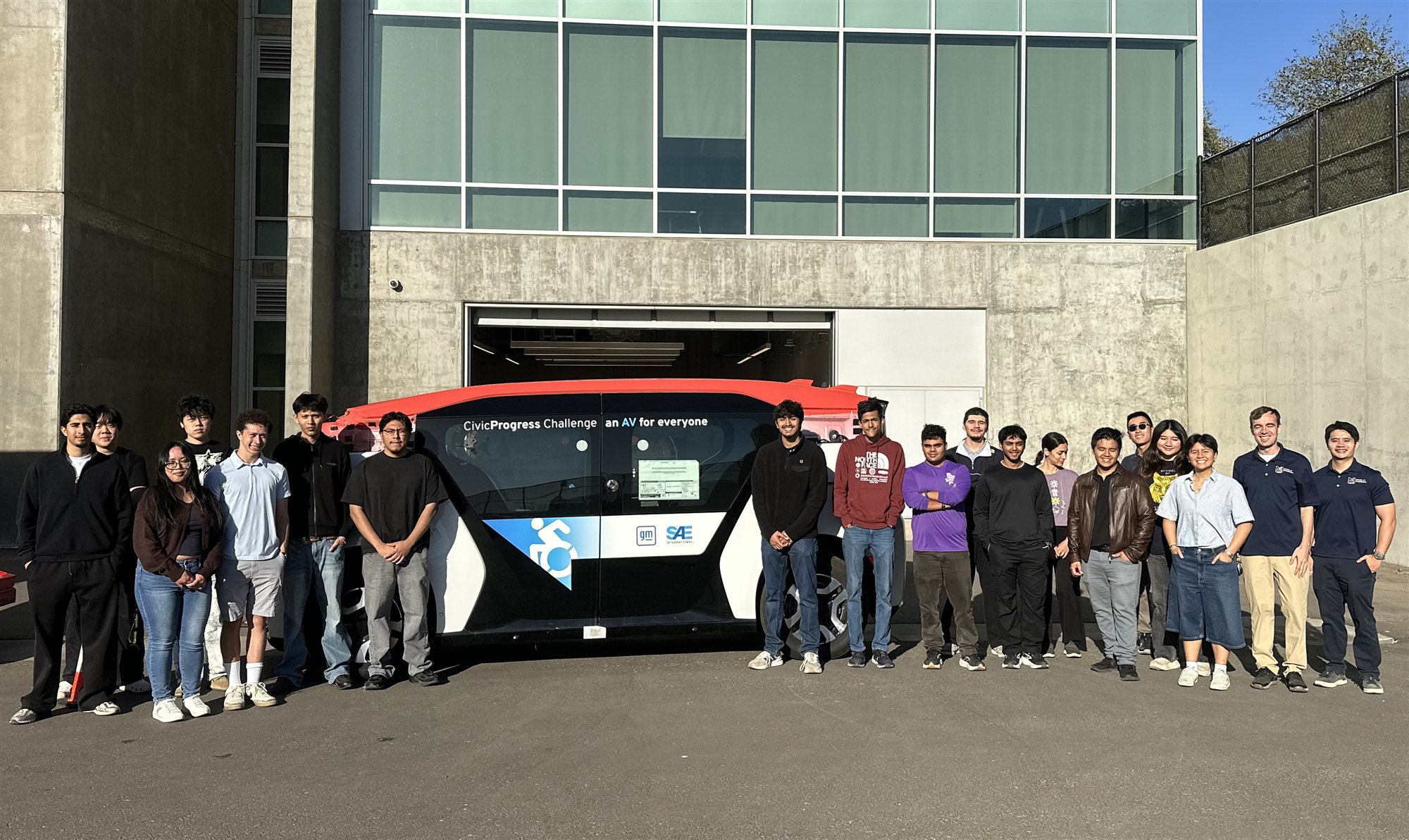 The UC Merced CivicProgress Challenge team standing beside the accessible autonomous vehicle